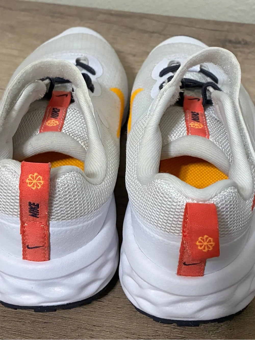 Girls Nike Kids White Sneakers with Pink Swoosh and Yellow Accent